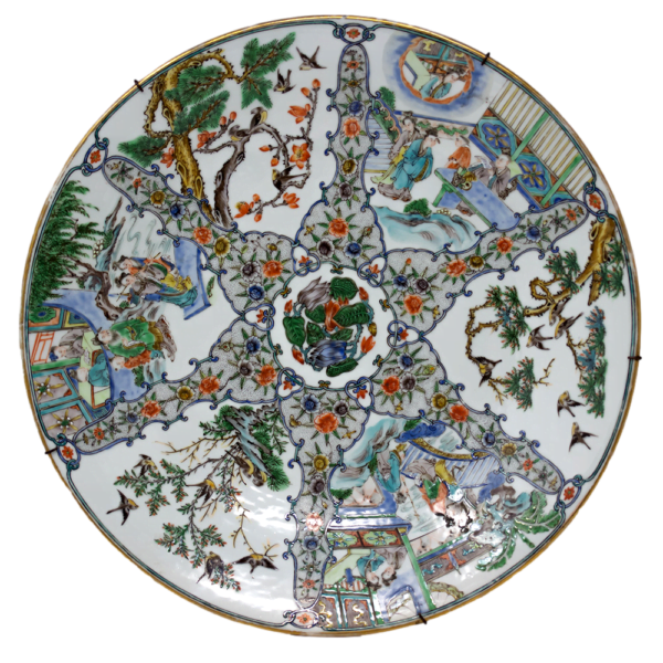 An image showing the front side of a Chinese porcelain 19th century charger featuring multiple figures and scrollwork decoration.