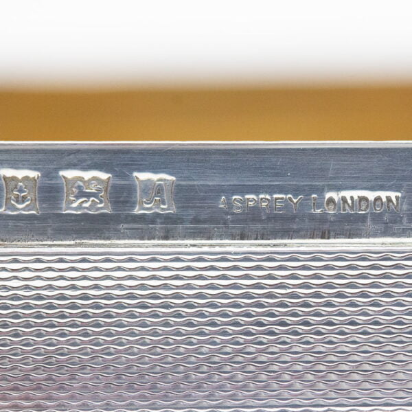 Close up of the hallmarks on the Asprey Horse Silver Cigarette Case
