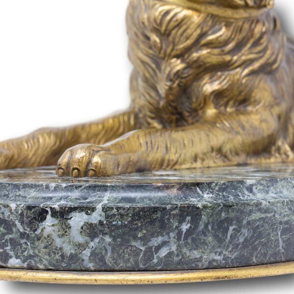 Close up of the dogs paw on the marble plinth
