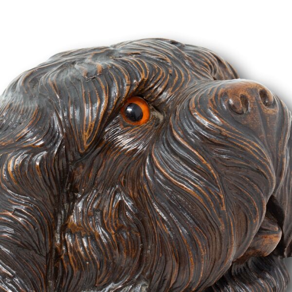 Close up of one side of the dogs face with the orange glass eyes