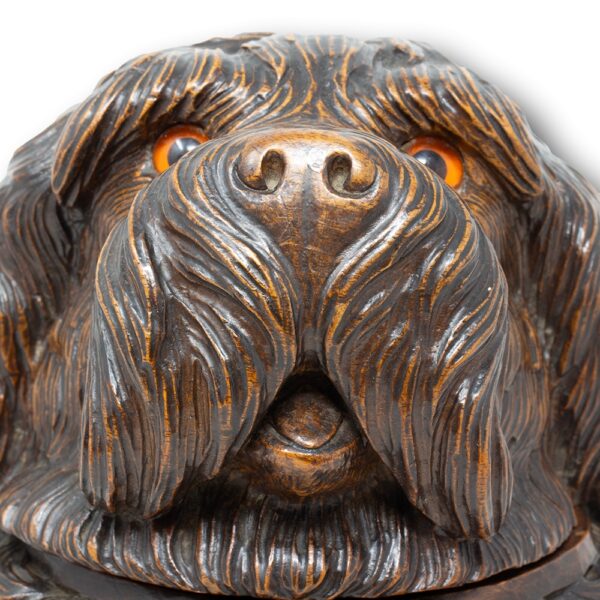 Close up of the dog from the front showing the detail of carving to the nose, mouth and both glass eyes